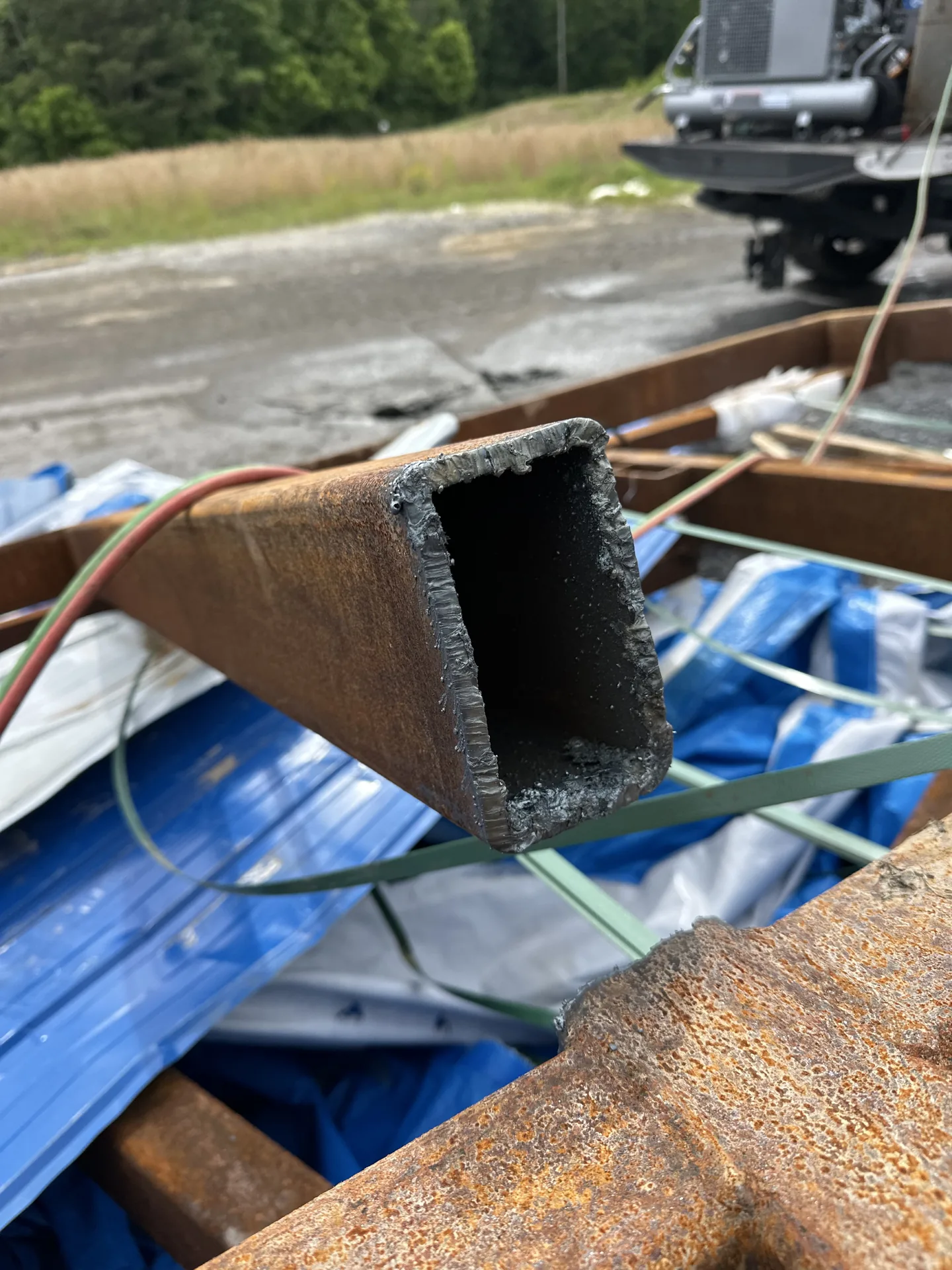 Cut end of rectangular steel tubing prepared for container loading
