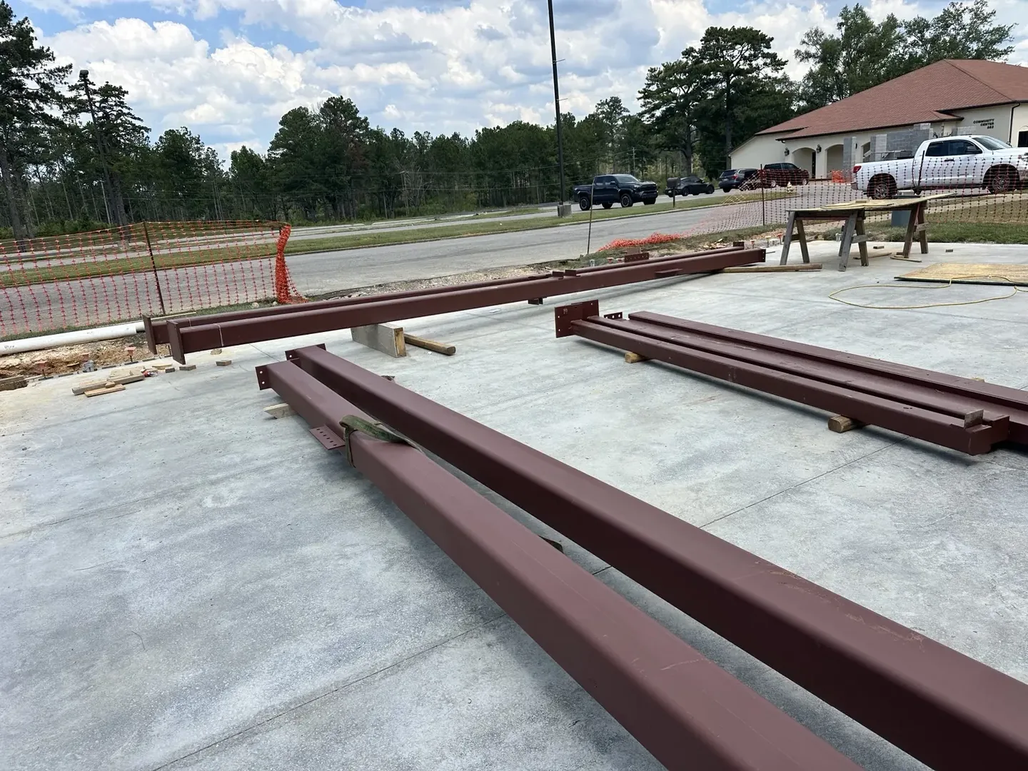 Commercial steel beams staged before shortening at the Fort McClellan jobsite