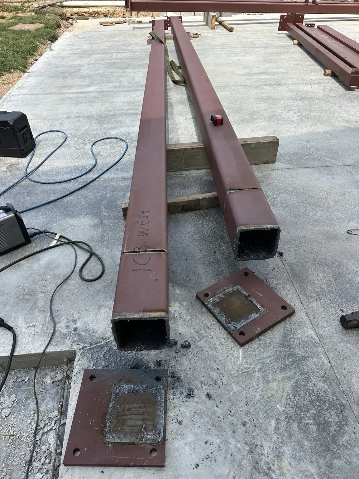 Cut steel beam ends with removed base plates ready for preparation