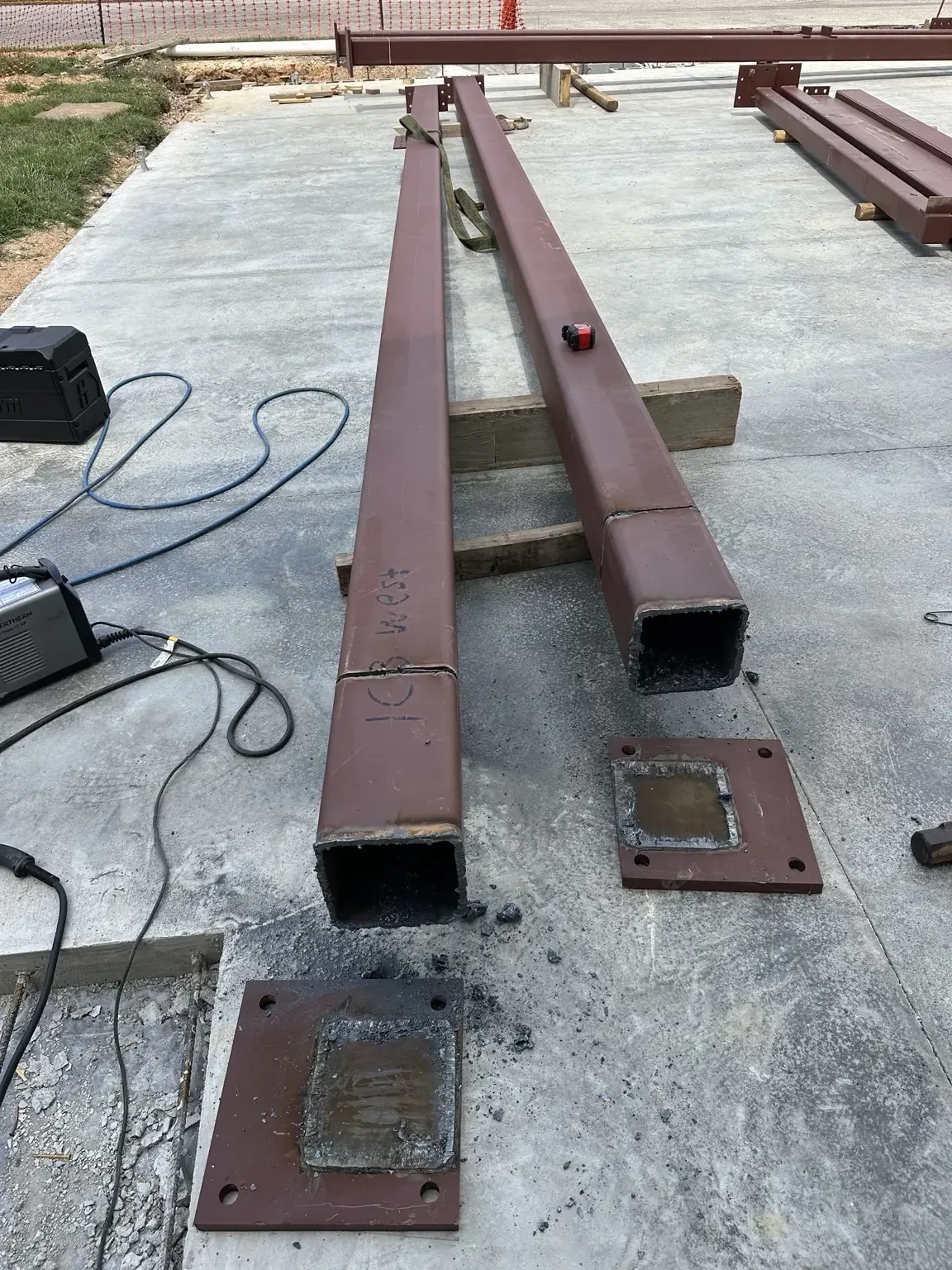 Shortened rectangular steel beam ends before the base plates were refitted