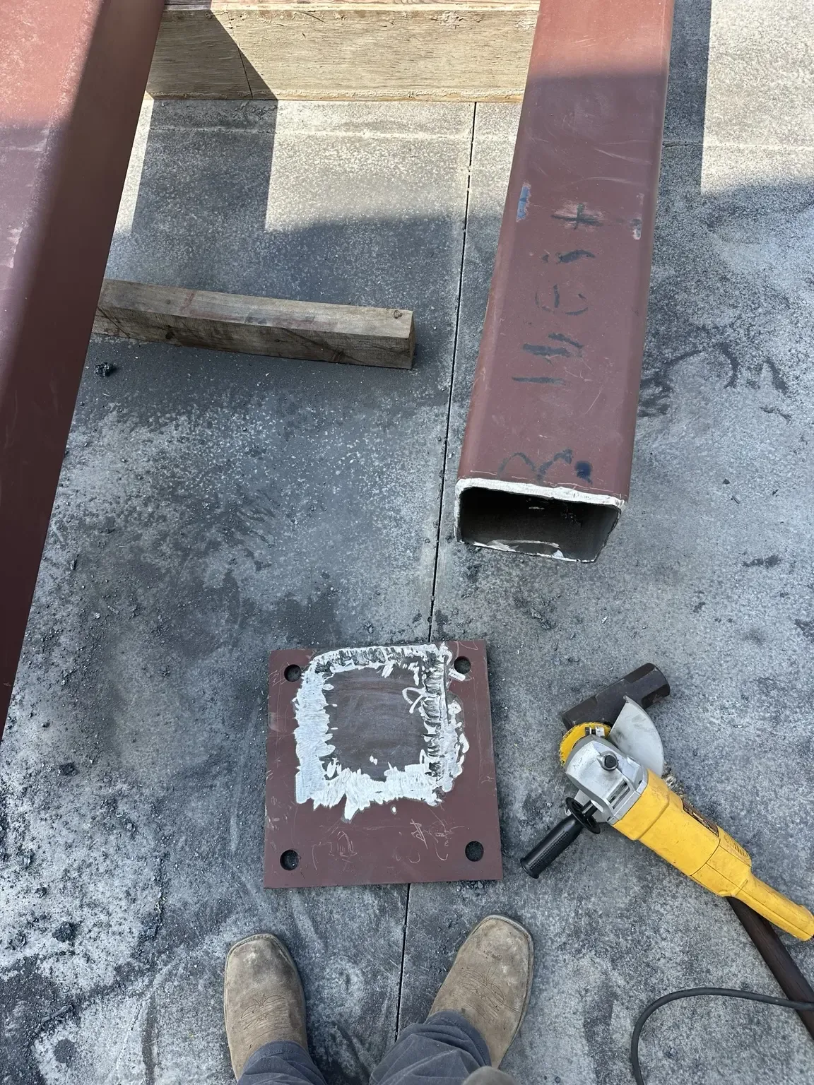 Steel base plate surface ground clean before being refitted to a shortened beam