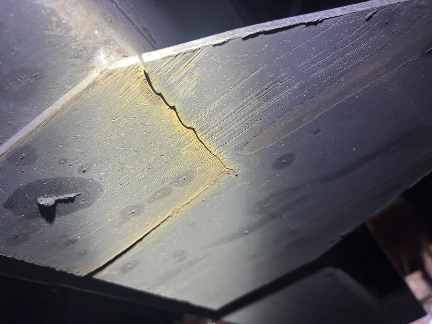 Underside view of the crack extending through the steel trailer frame