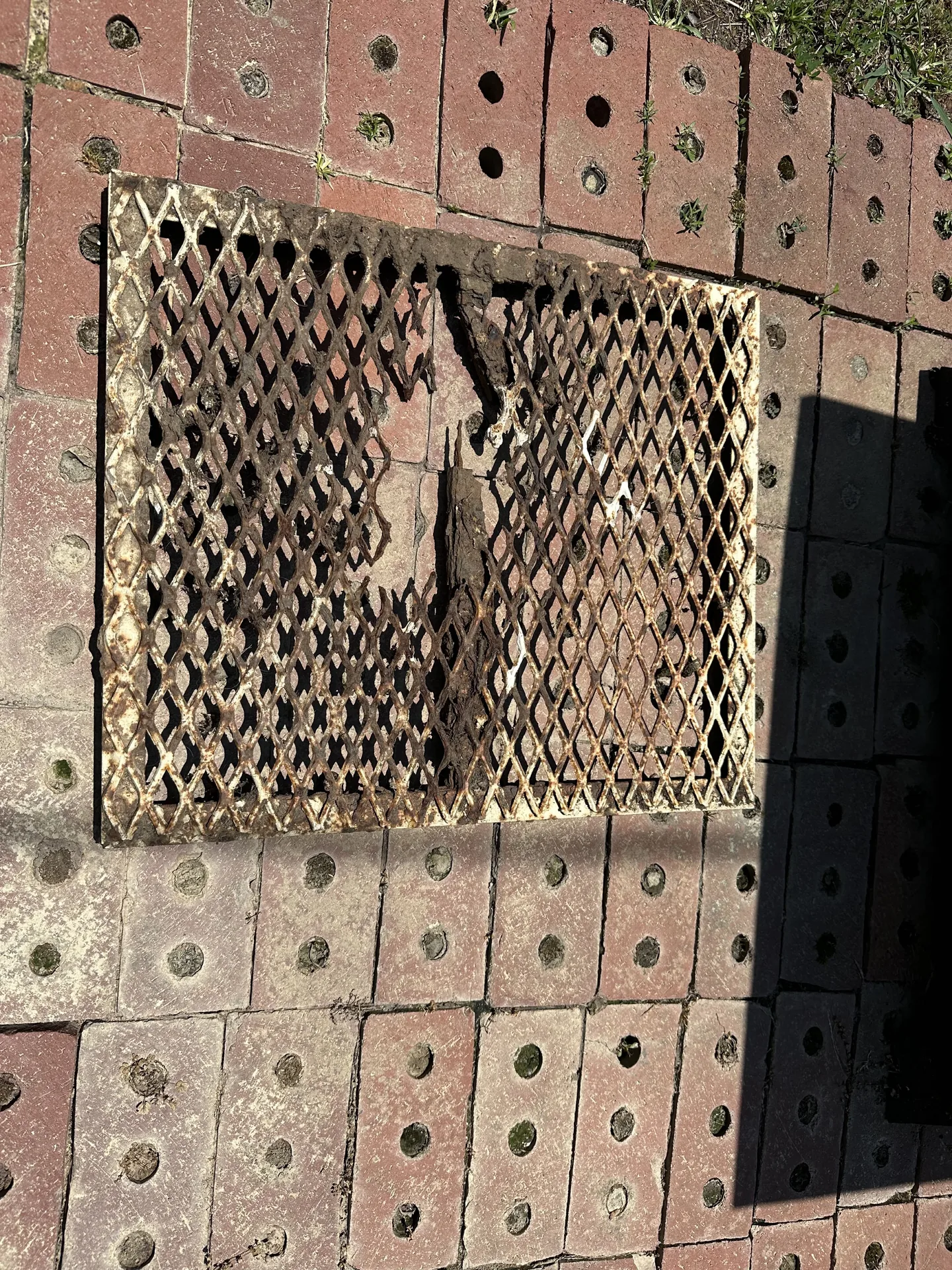 Rusted and damaged expanded-metal grill grate before repair