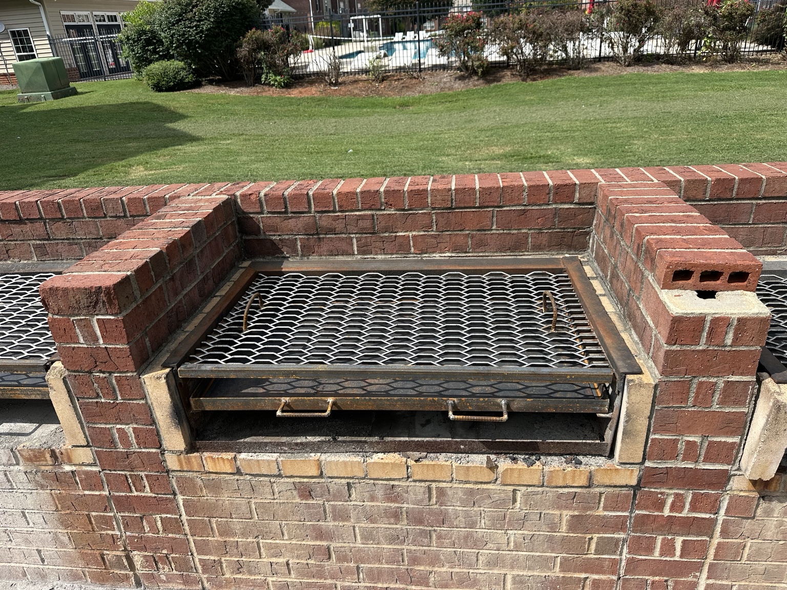 Completed custom steel grill components installed in an existing brick cooking station at Gamecock Village in Jacksonville, AL