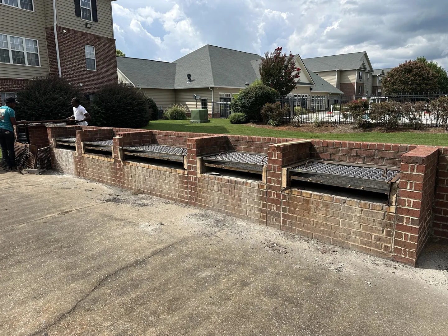 Five completed fabricated grill tops and ash pans installed at an apartment complex