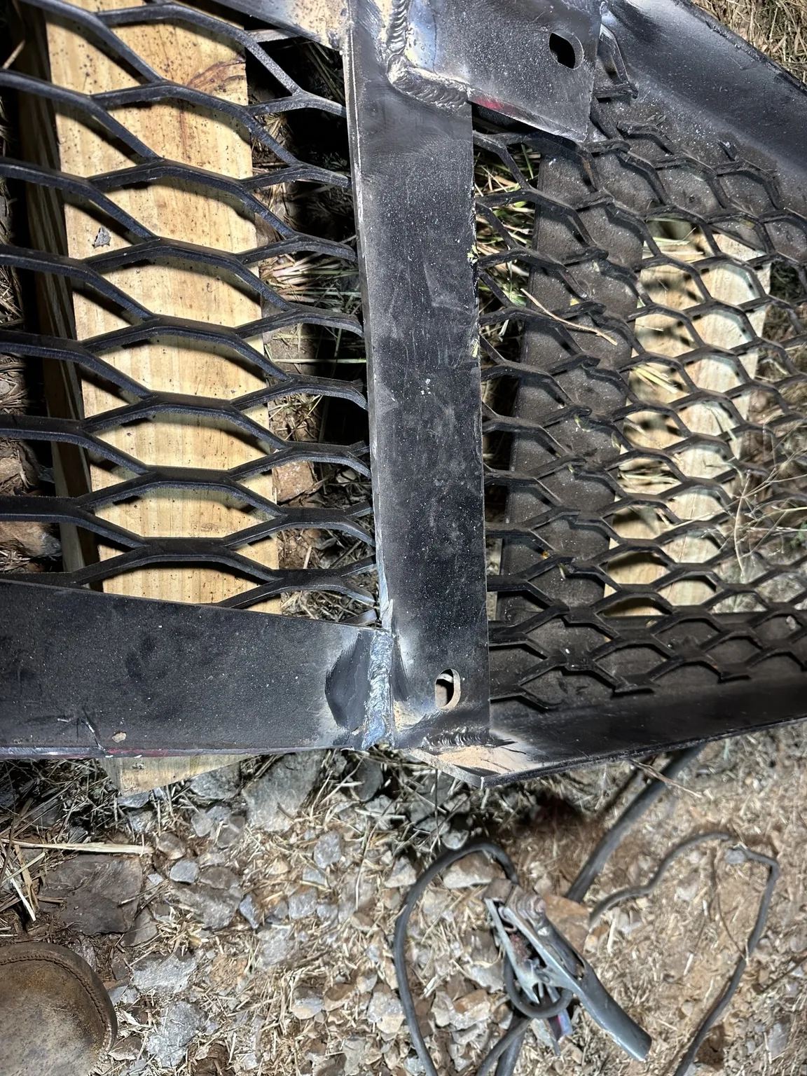 Steel crossmember and welded bracket beside the billboard's expanded metal