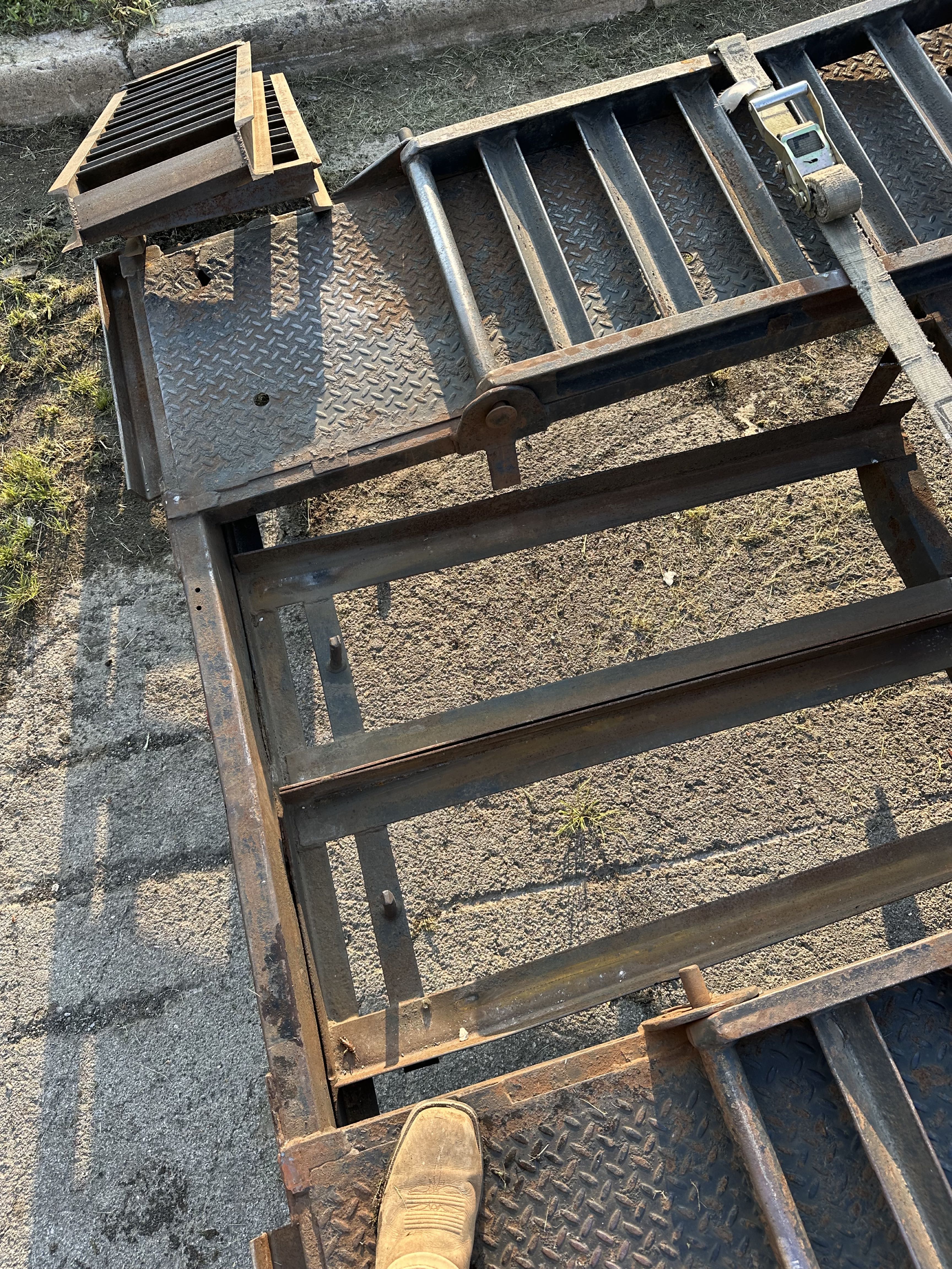 Damaged equipment trailer steel cut out and prepared for repair