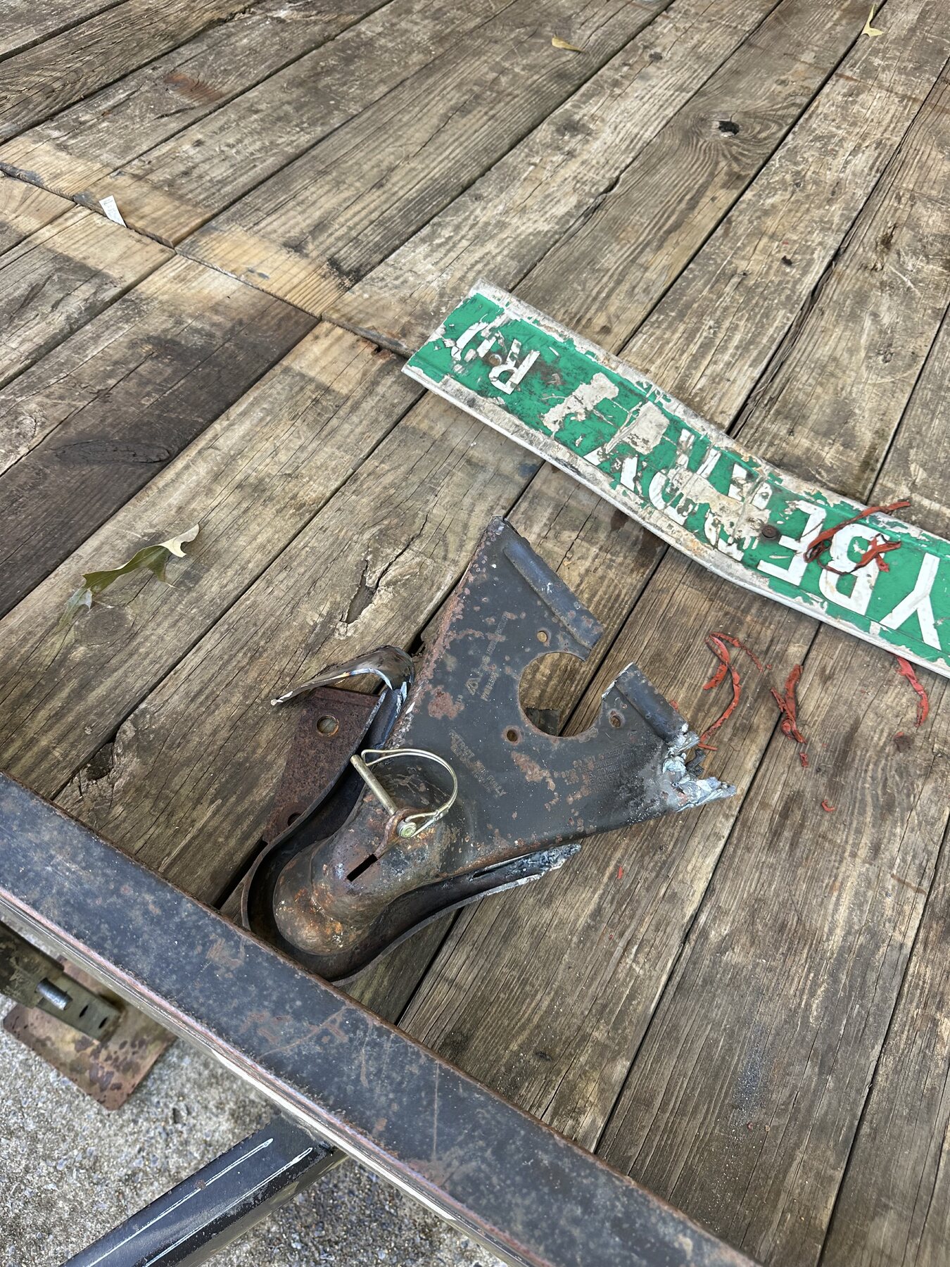 Old trailer hitch before replacement in Anniston, AL, shown after being cut off and removed