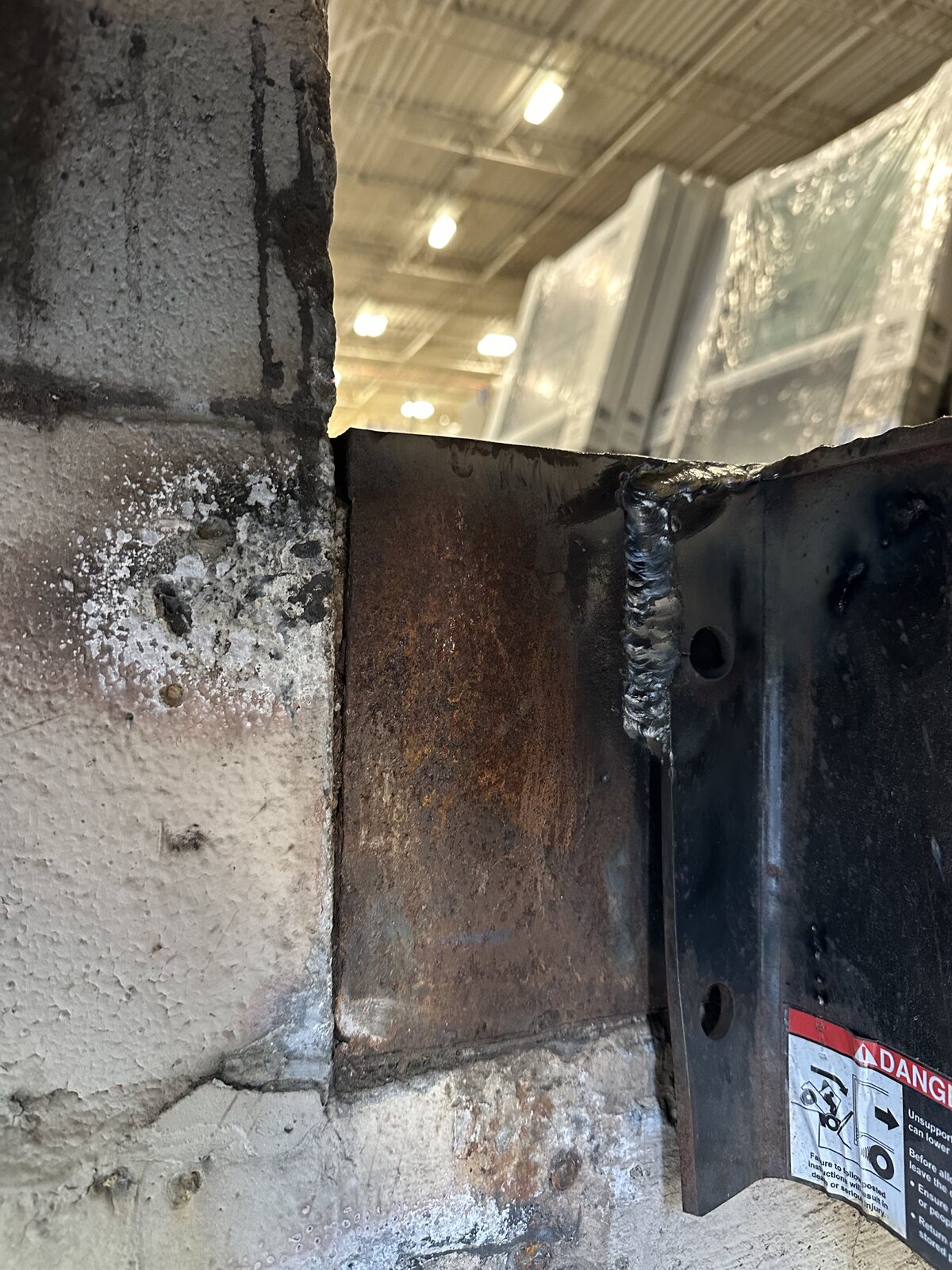 Close-up of a repaired steel connection on a commercial loading dock leveler